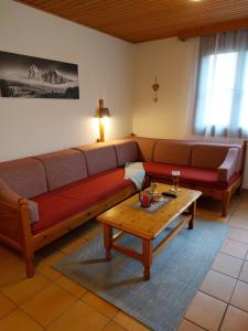 a living room with a couch and a coffee table at Apartment Gerlitzen Garden in Treffen
