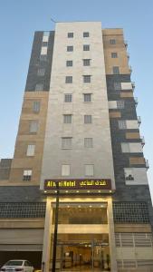 a tall building with a sign in front of it at فندق الساعي Alsai Hotel in Al ‘Utaybīyah