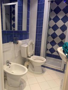 a blue and white bathroom with a toilet and a sink at Chez Chebil in rue Halevy - near the sea in Nice