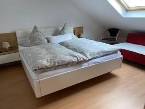 a bedroom with a large bed with a white bed frame at Ferienwohnung Hub in Nittel