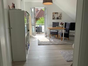 a hallway with a dining room and a dining table at Ferienwohnung Fleckeby Schlei Fjord Light in Fleckeby