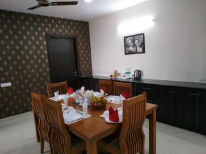a dining room with a table with a bowl of fruit on it at 2 BHK Corporate Service Apartment Manyata Tech Park in Bangalore
