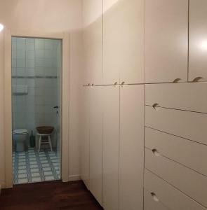 a bathroom with white cabinets and a toilet at Cairoli20 in Vicenza