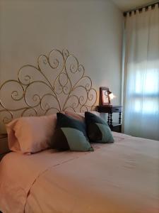 a bedroom with a large bed with pillows at Cairoli20 in Vicenza