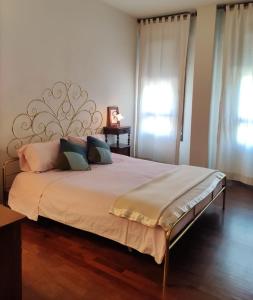 a bedroom with a large bed with pillows on it at Cairoli20 in Vicenza