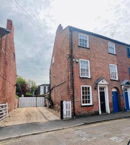 a red brick house with a blue door on a street at York House in Retford