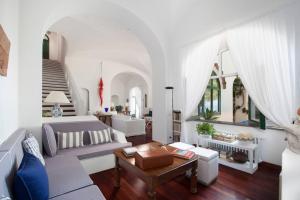 a living room with a couch and a table at La Villa Positano - Luxury villa with private sea access in Positano