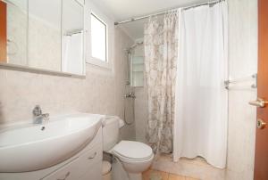 a bathroom with a sink and a toilet and a shower at Vicinia Guest House in Rhodes Town +15 photos
