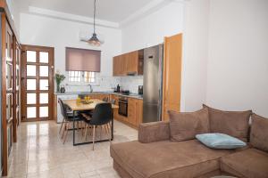 a living room and kitchen with a couch and a table at Vicinia Guest House in Rhodes Town