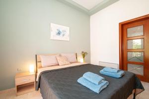 a bedroom with a bed with two towels on it at Vicinia Guest House in Rhodes Town