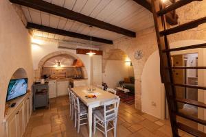 cocina con mesa y sillas en una habitación en Il Trullo Moore Alberobello, en Alberobello