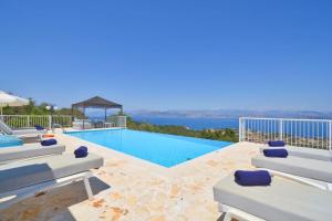 a villa with a swimming pool with a view at Villa Helios Corfu Kassiopi in Kelliá