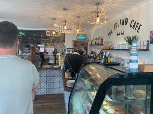 a group of people standing at the counter of a restaurant at Noraville Hamptons Style Beach House in Norah Head +29 photos