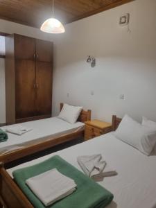 a bedroom with two beds with towels on them at Zeus Apartman in Panagia