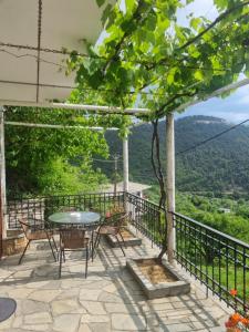 a patio with a table and chairs and a view at Zeus Apartman in Panagia
