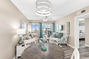 a living room with a table and a couch at Plantation 2308 in Gulf Shores