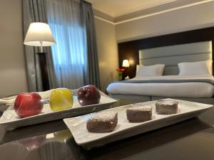 two plates of fruit on a table in a hotel room at Ramada by Wyndham Downtown Beirut in Beirut