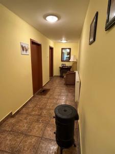 a hallway with a trash can in a room at Erdei Vendégház in Bögöt