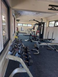 a gym with several tread machines in a room at Julie's Marvelous home in Dar es Salaam