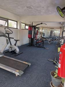 a gym with several exercise equipment in a room at Julie's Marvelous home in Dar es Salaam