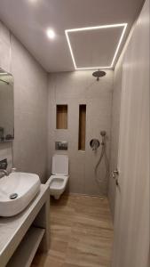 a bathroom with a sink and a toilet at Oasis in Kallithea Halkidikis +24 photos