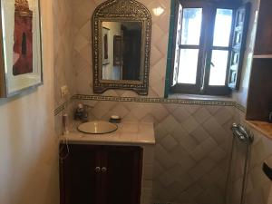 a bathroom with a sink and a mirror at Duplex vistas Alhambra in Granada