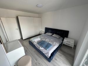 a small bedroom with a bed and a dresser at BesTer Apartment in Ferizaj