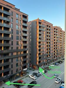 a view of a parking lot with two tall buildings at BesTer Apartment in Ferizaj