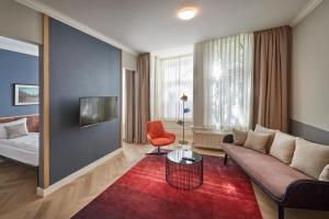 a living room with a couch and a red rug at Nova Apartments Amsterdam in Amsterdam