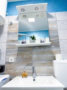 a bathroom with a sink and a mirror at Luxury Apartman ASIA Rijeka in Rijeka