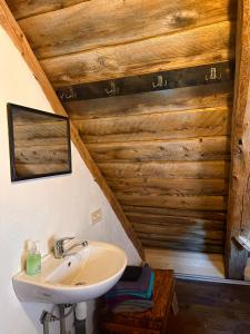 a bathroom with a sink and a wooden ceiling at Fontaine Mansion in Liepāja