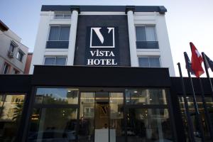 a sign for a vista hotel in front of a building at Vista Family Hotel Konyaaltı in Antalya