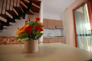 a vase of flowers sitting on a table in a kitchen at Salina in Rosolina Mare +34 photos