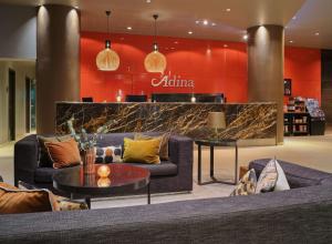 a lobby with couches and a counter in a store at Adina Apartment Hotel Frankfurt Neue Oper in Frankfurt/Main