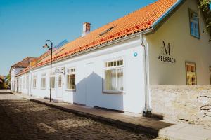 a white building on the side of a street at Meerbach Residents in Kuressaare