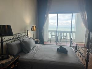 a bedroom with a bed with a blue hat on it at 2Bedroom Seaview @ Straits Quay in Bagan Jermal