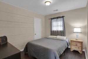 a bedroom with a bed and a table and a window at Small 2br East Knox apartment Pet friendly in Knoxville
