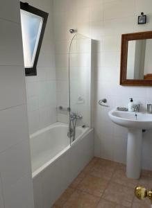 a bathroom with a bath tub and a sink at Apartamento HADE Golf in Huelva