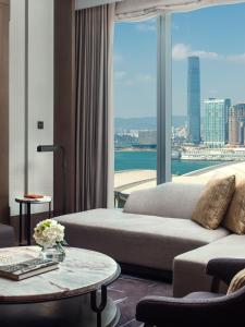 a living room with a couch and a large window at The St. Regis Hong Kong in Hong Kong