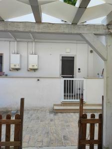 a white building with two lights on the wall at B&b Casa Vita COMFORT HOME in Marconia +14 photos