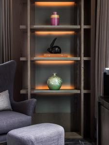 a book shelf with a vase in a room at The St. Regis Hong Kong in Hong Kong