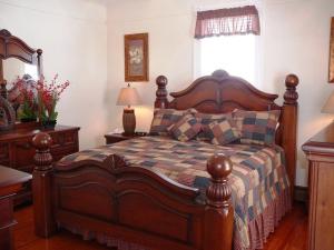 a bedroom with a large wooden bed and a window at A Awesome Shenandoah Valley View in Elkton