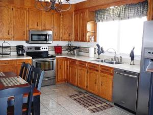 a kitchen with wooden cabinets and stainless steel appliances at A Awesome Shenandoah Valley View in Elkton