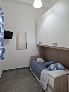 1 dormitorio con 1 cama y armarios blancos en giuchi home casa vacanze, en Avola
