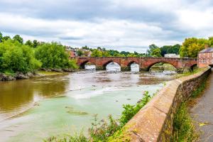 a bridge over a river in a city at Pyecroft Cottage in Chester