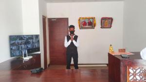 a man standing in a room with a mask on his face at Lha-Zes in Leh