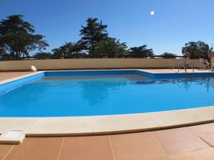 a large swimming pool with blue water at Estoril Casino 3 Bedrooms With Pool in Estoril