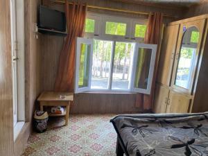 a bedroom with a bed and a window at Moon Light Guest House Khaplu in Khaplu