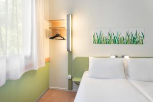 een slaapkamer met een bed en een raam bij B&B HOTEL Zaragoza Plaza Mozart in Zaragoza