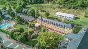 una vista aérea de un gran edificio con piscina en L'HÔTEL DES BAINS - Salles-la-Source en Salles-la-Source